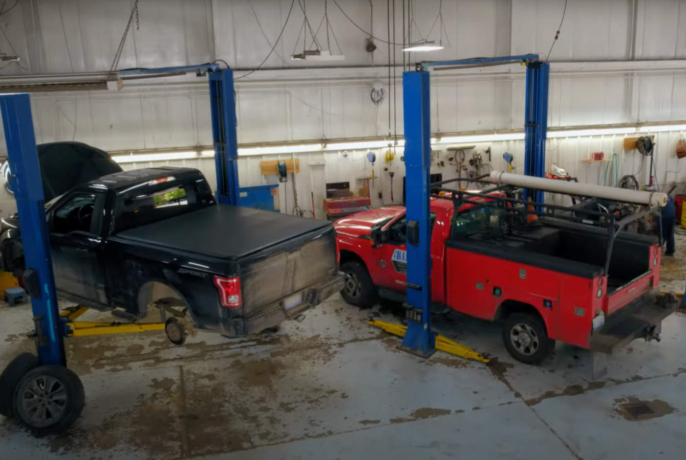 Trucks on Hoists in auto repair shop