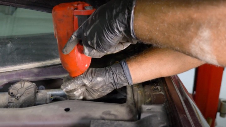 Removing strut assembly upper mounting nuts Removing strut assembly upper mounting nuts