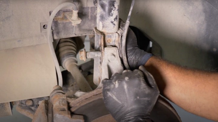 Removing strut lower mounting nuts Removing strut lower mounting nuts