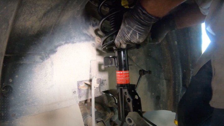 Inserting new strut assembly in vehicle Inserting new strut assembly in vehicle