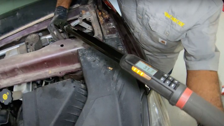 Installing remaining strut assembly upper mounting nuts Installing remaining strut assembly upper mounting nuts