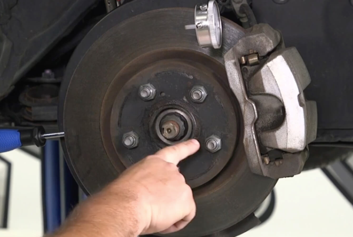 Tech pointing to lug nuts