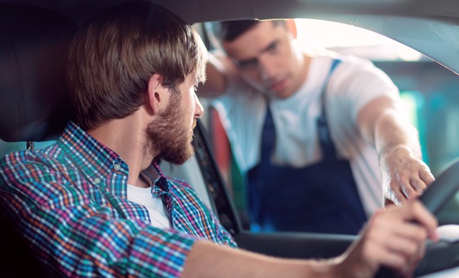 Mechanic-Explaining-To-Customer-In-Their-Vehicle Mechanic-Explaining-To-Customer-In-Their-Vehicle