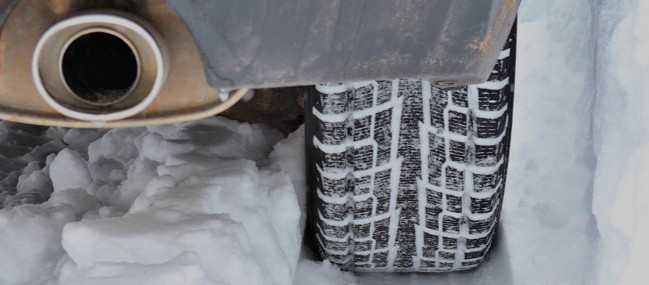 Car-Tire-Muffler-Close-Up-In-Snow Car-Tire-Muffler-Close-Up-In-Snow